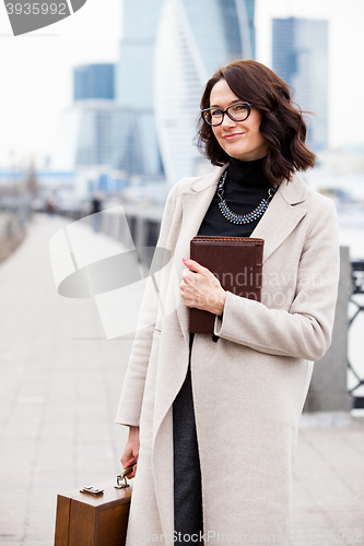 Image of smiling middle-aged woman with books