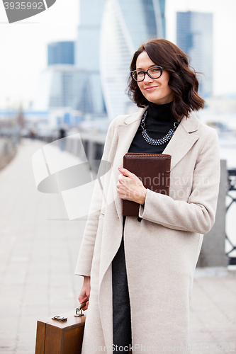 Image of smiling middle-aged woman with books