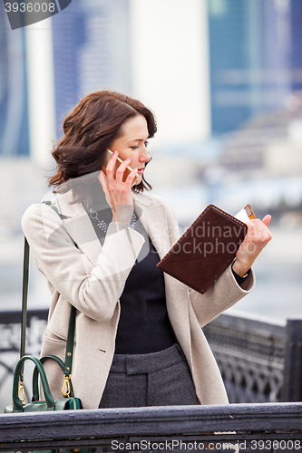 Image of Woman talking on cell phone