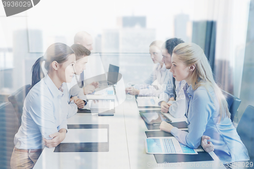 Image of smiling business people having conflict in office