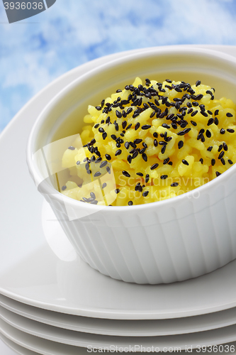 Image of Rice (boiled with curcuma) and black sesame topping