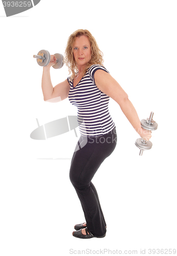 Image of Woman workout with two dumbbells.