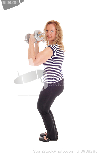 Image of Woman workout with dumbbells.