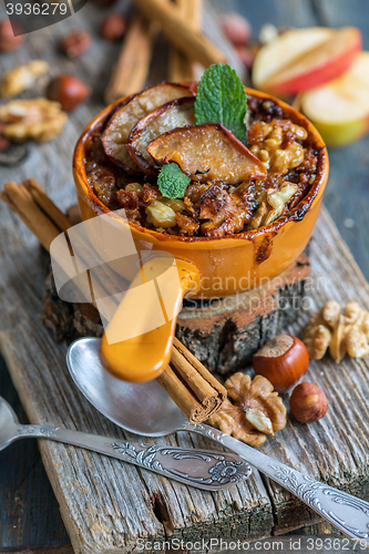 Image of Oatmeal with apple, spices and honey. View from above.