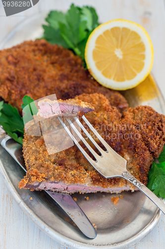 Image of Piece of beef schnitzel on a fork.