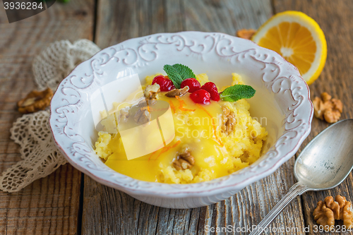 Image of Bowl with millet porridge, lemon cream and nuts.