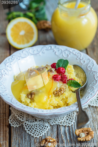 Image of Cup of porridge of millet, berries, nuts and lemon cream.