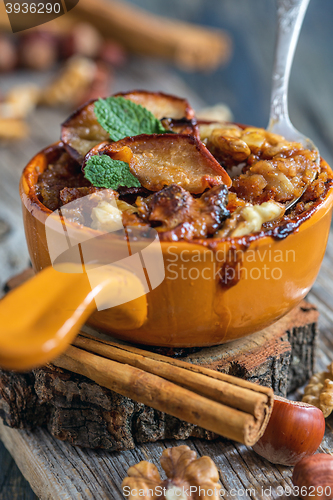 Image of Ceramic bowl of oatmeal baked with apple and cinnamon.