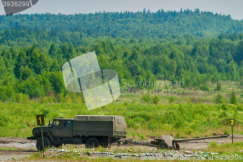 Image of army truck transports a gun