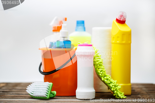 Image of Bucket with cleaning items on light background