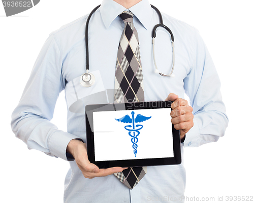 Image of Doctor holding tablet - Caduceus symbol