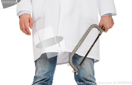 Image of Crazy doctor is holding a big saw in his hands