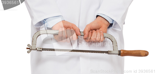 Image of Crazy doctor is holding a big saw in his hands