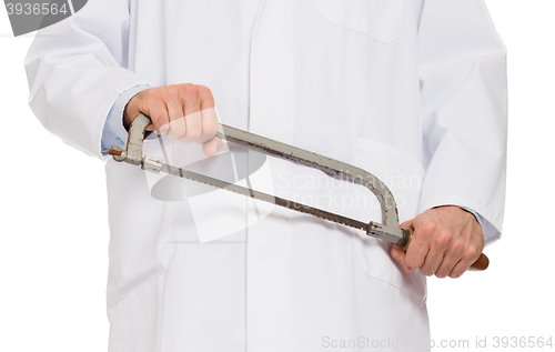 Image of Crazy doctor is holding a big saw in his hands