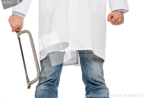 Image of Crazy doctor is holding a big saw in his hands