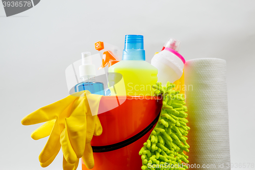 Image of Bucket with cleaning items on light background