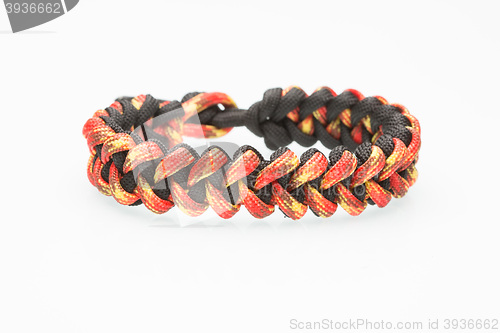 Image of black and orange braided bracelet on white background