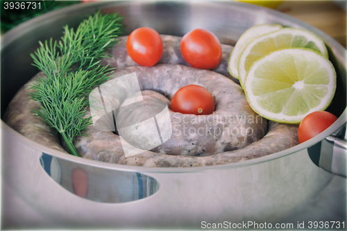 Image of Homemade pork sausage in a frying pan for a roast.