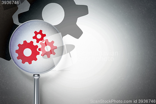 Image of Marketing concept:  Gears with optical glass on digital background