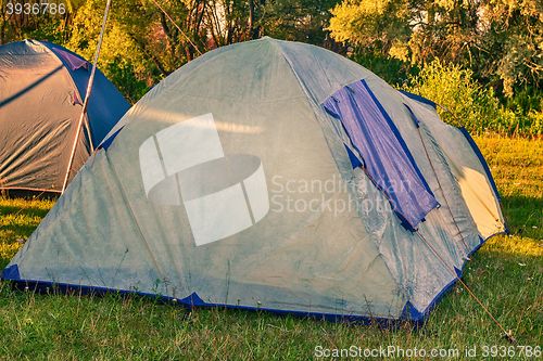 Image of Private camping tent on the meadow near the river.