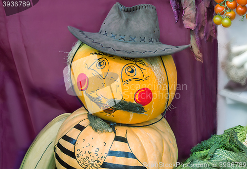 Image of Funny statue made from two pumpkins in the form of a man in a ha