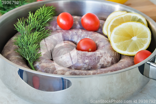 Image of Homemade pork sausage in a frying pan for a roast.