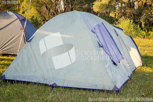 Image of Private camping tent on the meadow near the river.