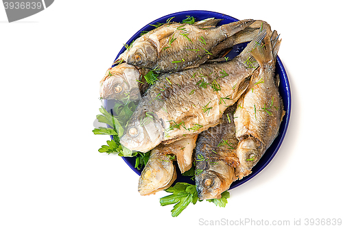 Image of Roasted carp on a plate on a white background.
