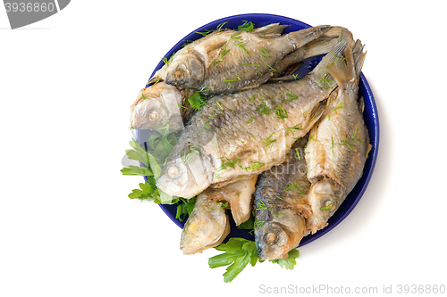 Image of Roasted carp on a plate on a white background.