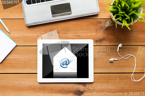 Image of close up of tablet pc computer on wooden table