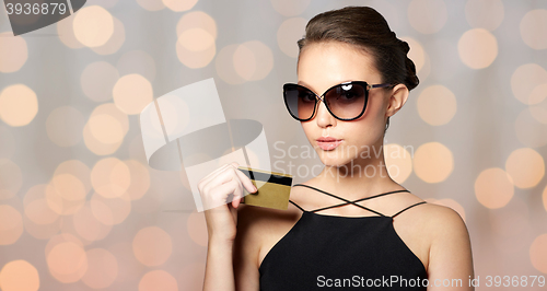 Image of beautiful young woman in elegant black sunglasses