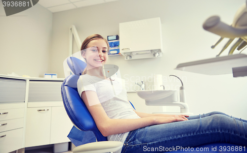 Image of happy patient girl at dental clinic office