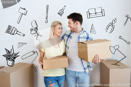 Image of smiling couple with big boxes moving to new home