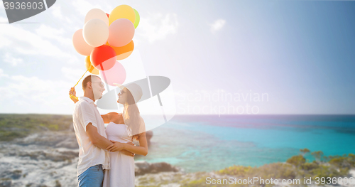 Image of smiling couple with air balloons outdoors