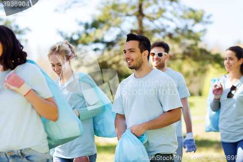 Image of group of volunteers with garbage bags in park