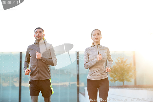 Image of happy couple running upstairs on city stairs