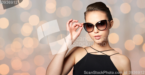 Image of beautiful young woman in elegant black sunglasses