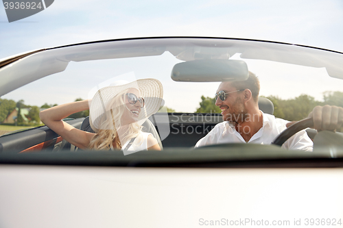 Image of happy man and woman driving in cabriolet car