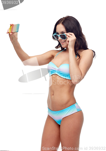 Image of woman in swimsuit taking selfie with smatphone