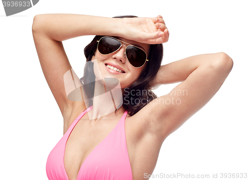 Image of happy woman in sunglasses and swimsuit