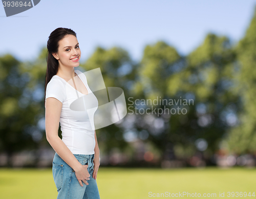 Image of happy young woman or teenage girl in white t-shirt