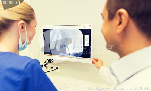 Image of close up of dentist and assistant at dental clinic