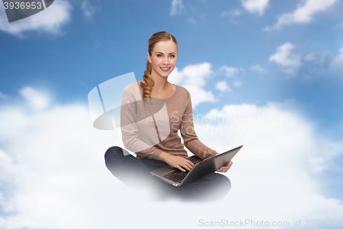 Image of young woman sitting with laptop