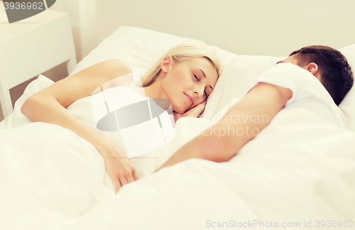 Image of happy couple sleeping in bed at home