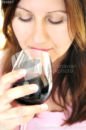 Image of Mature woman with a glass of red wine