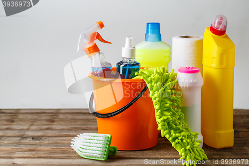 Image of Bucket with cleaning items on light background