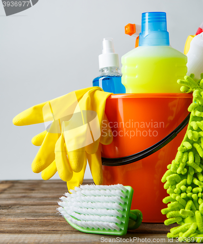 Image of Bucket with cleaning items on light background