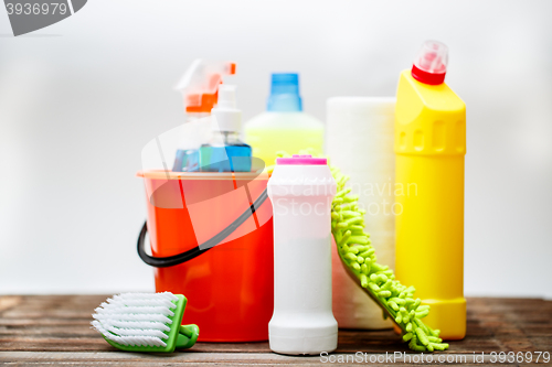 Image of Bucket with cleaning items on light background