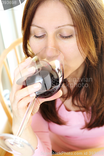 Image of Mature woman with a glass of red wine