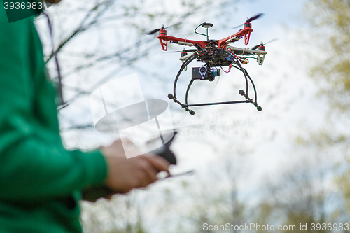 Image of Man controling a drone.